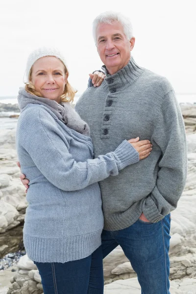 Романтическая старшая пара на скалистом пляже — стоковое фото