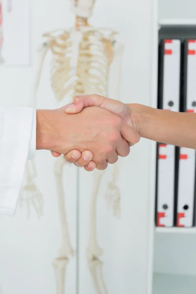 Extreme close-up of a doctor and patient shaking hands — Stock Photo, Image