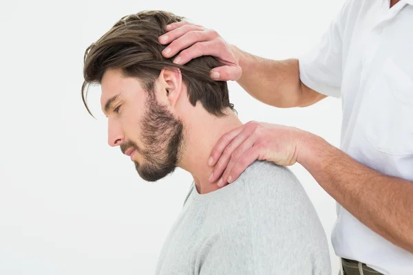 Side view of a man getting the neck adjustment done Royalty Free Stock Photos