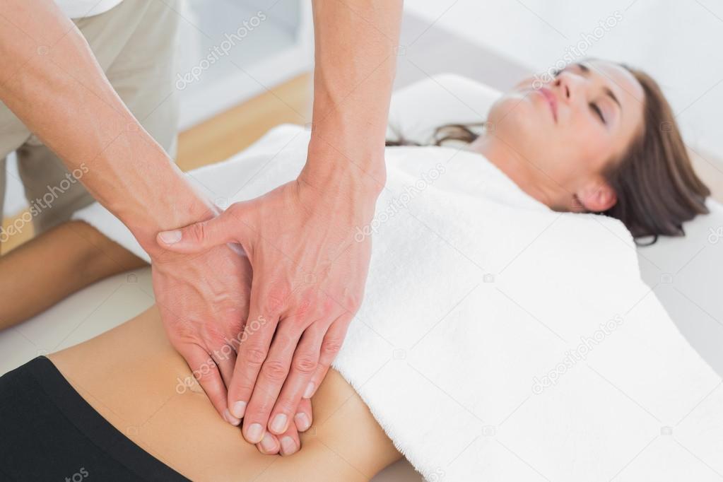 Close-up of a physiotherapist massaging woman's body
