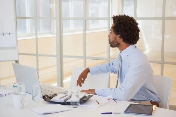 Serious businessman sitting at office desk