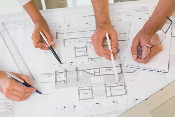 Several hands working on blueprints — Stock Photo, Image