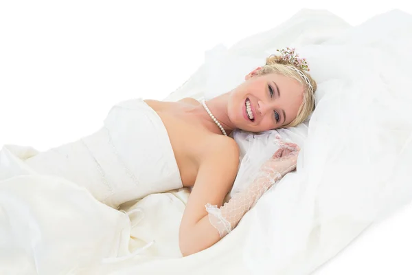 Elegant bride lying over white background — Stock Photo, Image