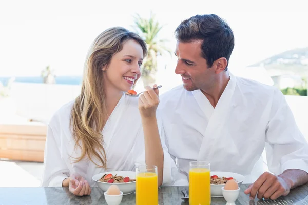 Smiling couple having breakfast — Stock Photo, Image