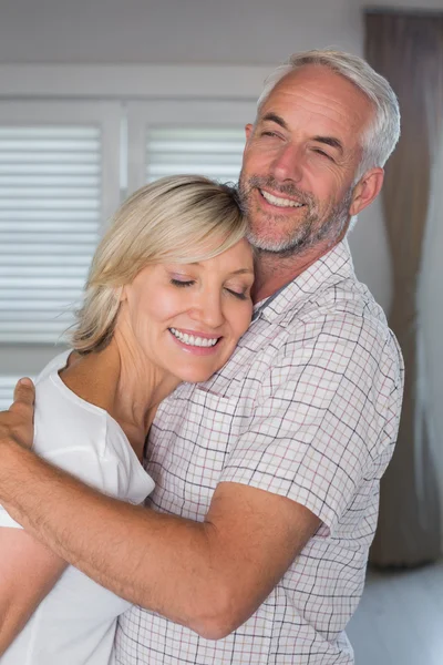 Mature couple embracing at home — Stock Photo, Image