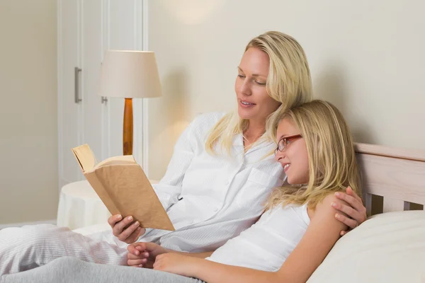 Matka a dcera čtení románu v posteli — Stock fotografie