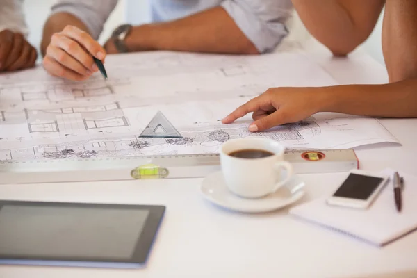 Mid section of business people working on blueprints — Stock Photo, Image