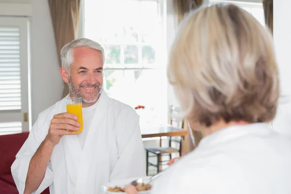 Smiling mature man having breakfast with cropped woman — Stock Photo, Image