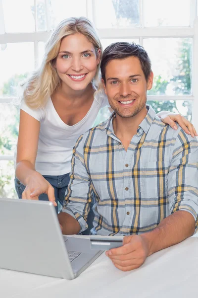 http://st.depositphotos.com/2665037/4258/i/450/depositphotos_42585763-Smiling-young-couple-doing-online-shopping-at-home.jpg