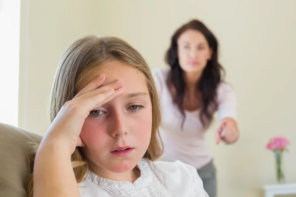 Girl with mother scolding her in background — Stock Photo, Image