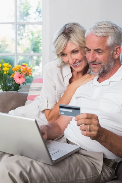 Mature couple doing online shopping at home — Stock Photo, Image