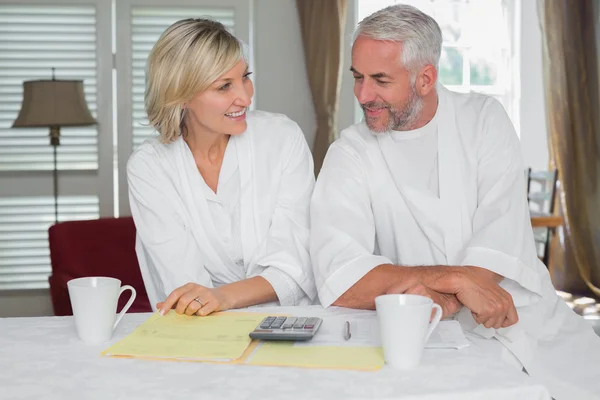 Casual mature couple with home bills and calculator — Stock Photo, Image