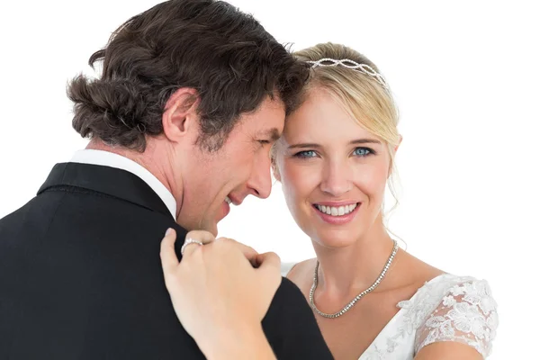 Bride embracing groom over white background — Stock Photo, Image