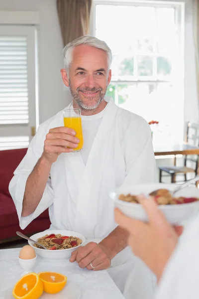 Mature man having breakfast with cropped woman — Stock Photo, Image