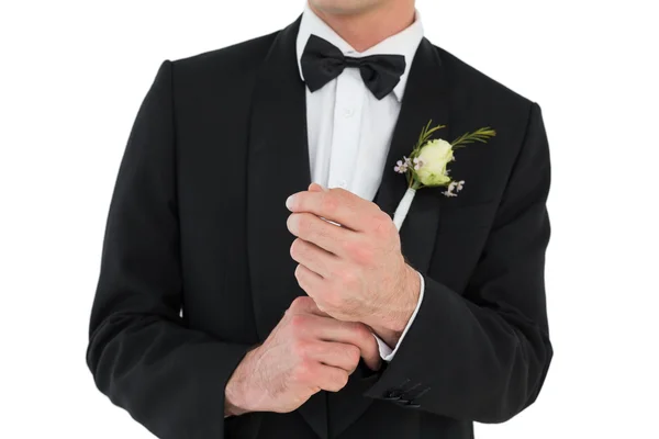 Mid section of groom adjusting cuff links — Stock Photo, Image