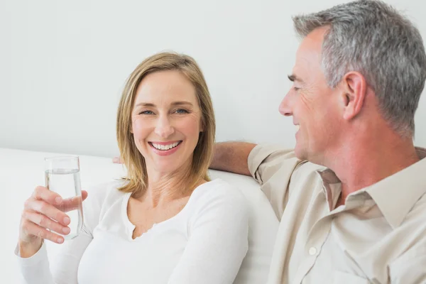 Relaxed couple with a glass of water — Stock Photo, Image