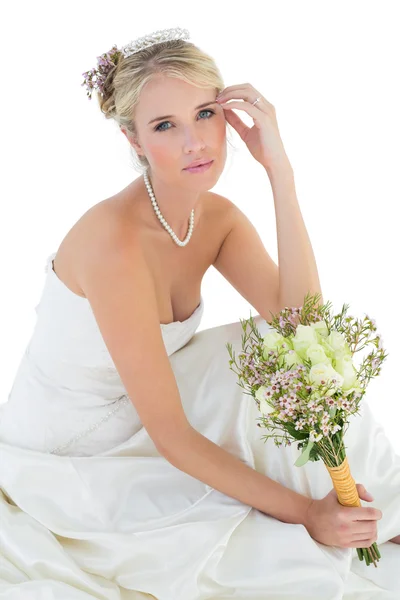 Sensuous bride holding rose bouquet over white background — Stock Photo, Image