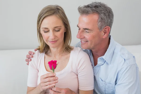 Happy romantic couple with a flower — Stock Photo, Image
