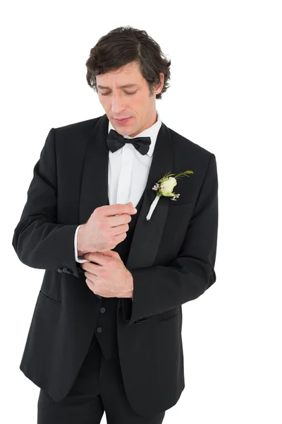 Handsome groom in tuxedo adjusting cuff link — Stock Photo, Image