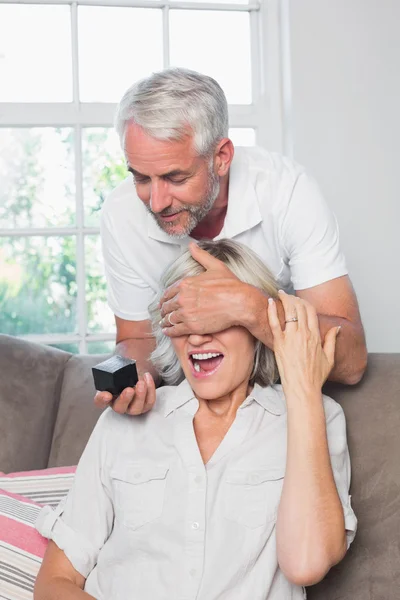 Mature man surprising woman with a wedding ring — Stock Photo, Image