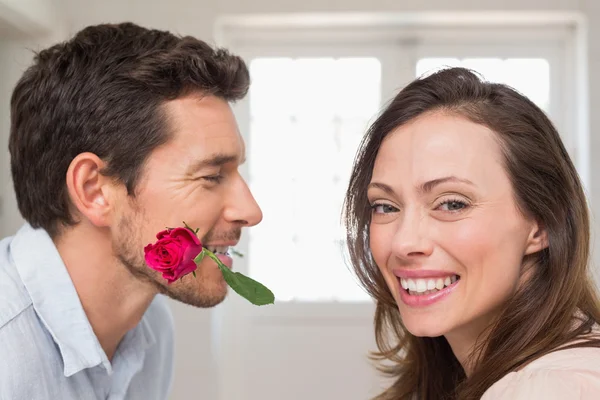 Loving couple with a rose at home — Stock Photo, Image