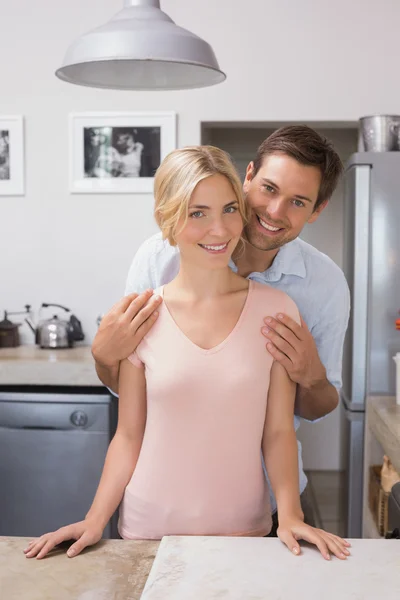 Happy loving young couple in the kitchen — Stock Photo, Image