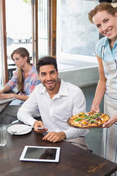 Serveerster pizza te geven aan man op koffie shop — Stockfoto