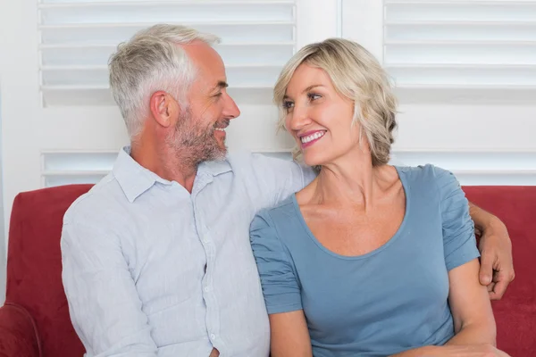 Relaxed mature couple sitting on couch — Stock Photo, Image