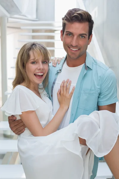 Portrait of a smiling man carrying woman — Stock Photo, Image