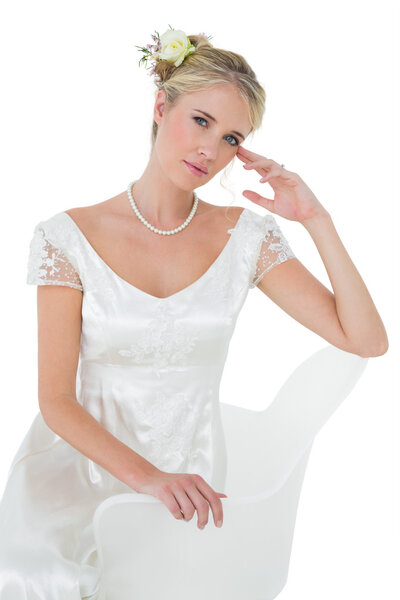 Beautiful bride sitting on chair over white background Stock Photo