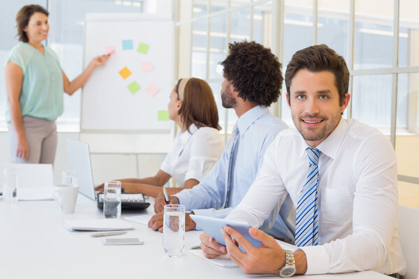 Young businessman with colleagues in boardroom meeting Royalty Free Stock Images