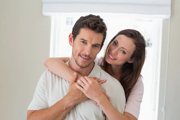 Loving woman embracing man from behind Royalty Free Stock Photos