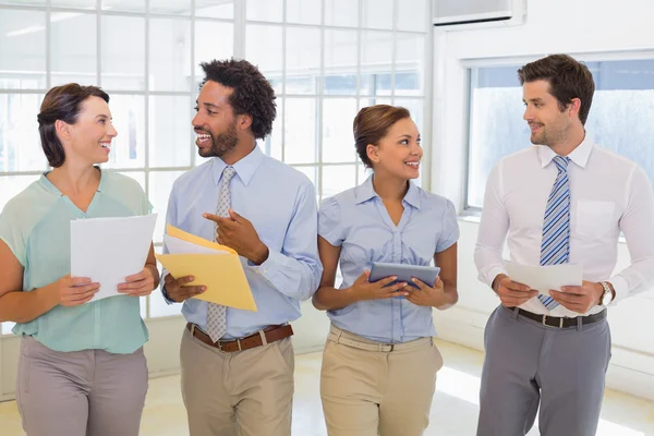 Business colleagues holding folders in office Stock Photo