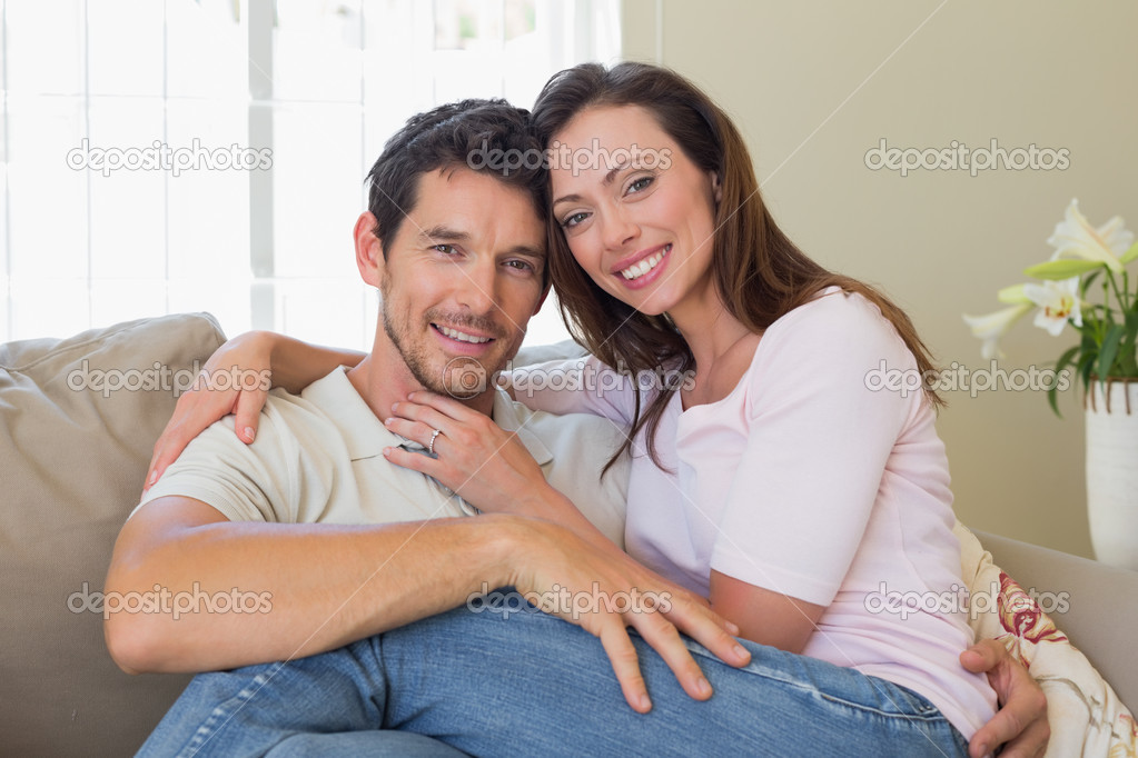 Portrait of a loving couple sitting on couch