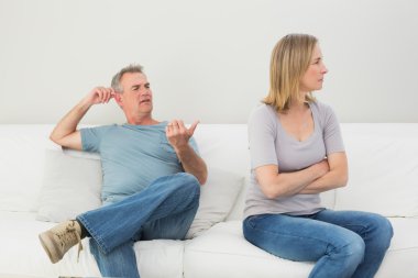 Unhappy couple not talking after an argument at home clipart