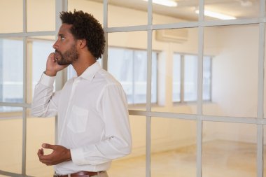 Ofiste cep telefonu kullanan bir iş adamı