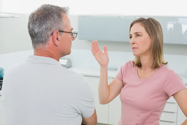 Unhappy couple having an argument in kitchen — Stock Photo, Image