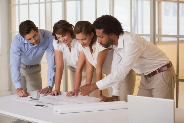 Architects working on blueprints at office — Stock Photo, Image