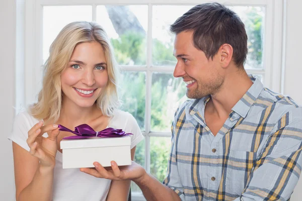 Beautiful young blonde receiving a gift box — Stock Photo, Image
