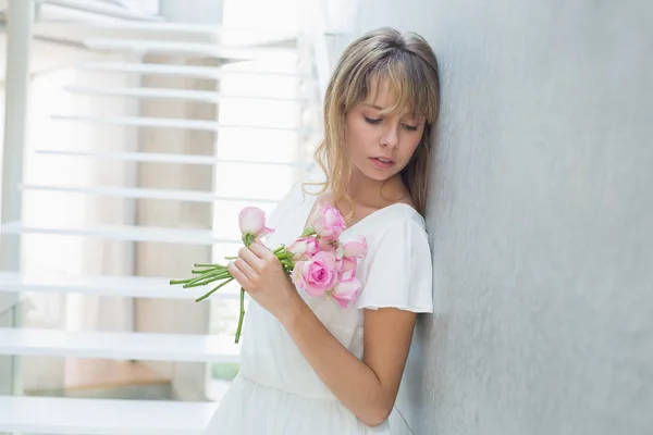 Mooie triest jonge vrouw met bloemen — Stockfoto