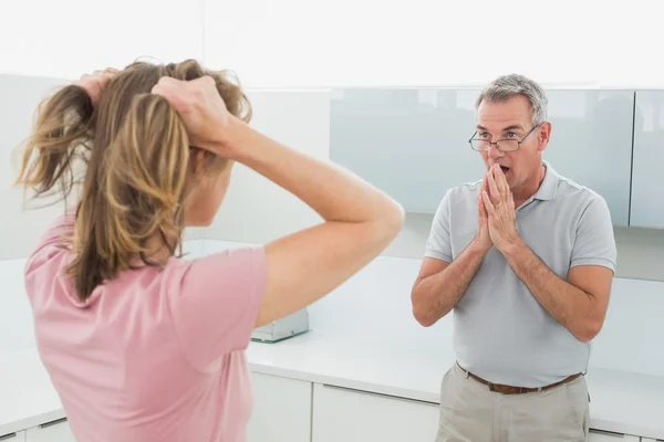 Unhappy couple having an argument in kitchen — Stockfoto