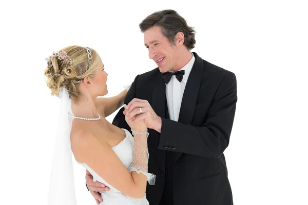 Bride and groom dancing over white background — Stock Photo, Image