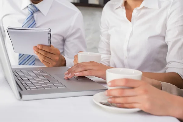 Mid section of three business people using laptop — Stock Photo, Image