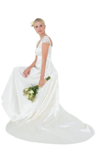 Portrait of bride holding bouquet over white background — Stock Photo, Image