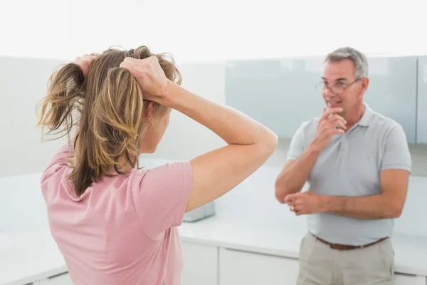 Unhappy couple having an argument in kitchen — Stockfoto