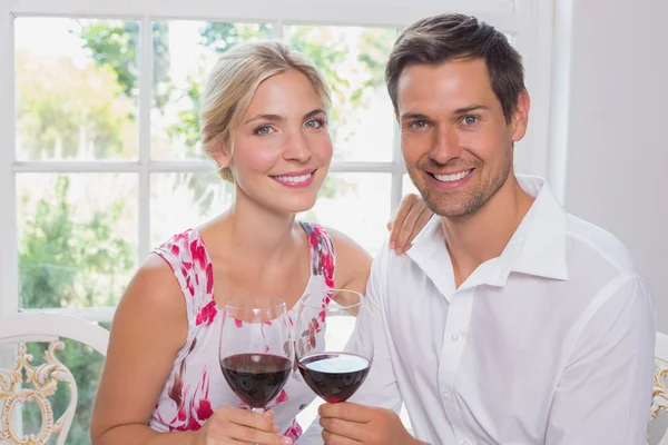 Loving couple with wine glasses at home — Stock Photo, Image