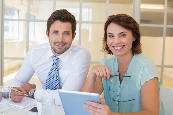 Smiling business people with digital tablet in office — Stock Photo, Image