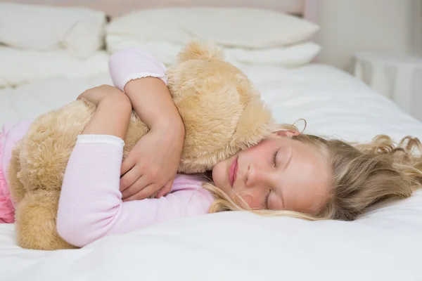Giovane ragazza che dorme con peluche a letto — Foto Stock