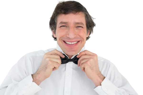 Portrait of groom adjusting bow tie — Stock Photo, Image