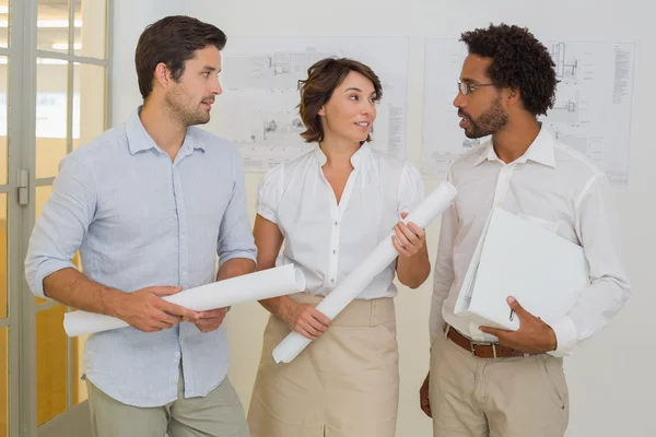Business colleagues with blueprints at office — Stock Photo, Image